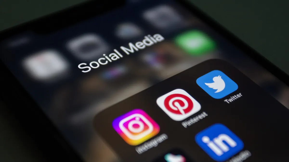 Close-up of a smartphone displaying colorful social media app icons, representing the reach of influencer marketing